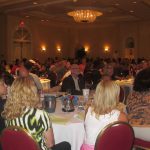Hall full of tables of people at annual conference