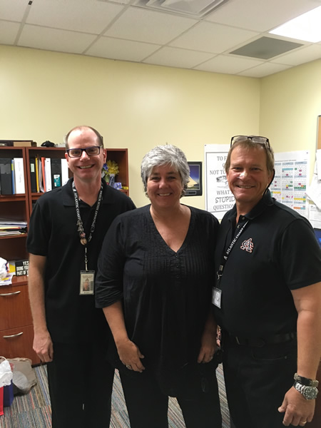 3 members of staff wearing black clothes