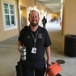 Man holding safety cup wearing black