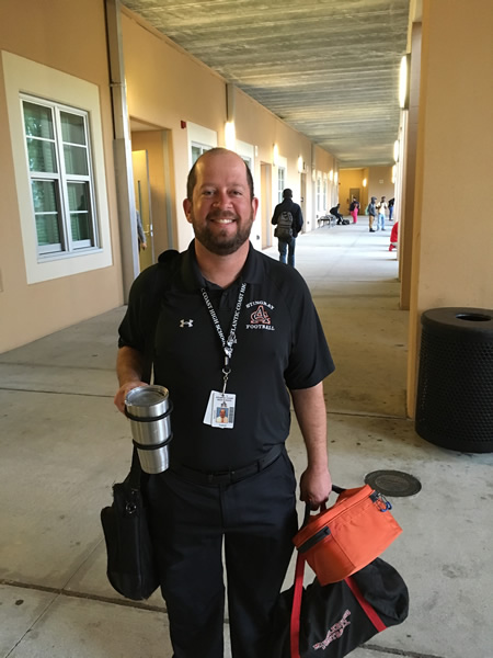 Man holding safety cup wearing black
