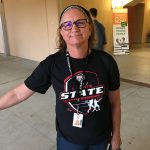 Lady wearing black tennis state championships t shirt