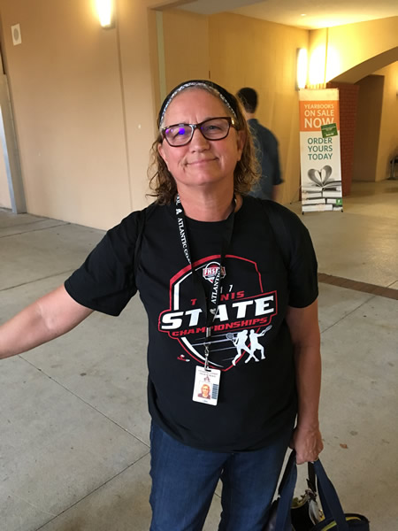 Lady wearing black tennis state championships t shirt