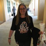 Woman wearing black softball tshirt