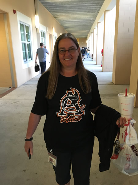 Woman wearing black softball tshirt