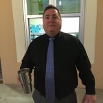 Man in blue tie and black shirt