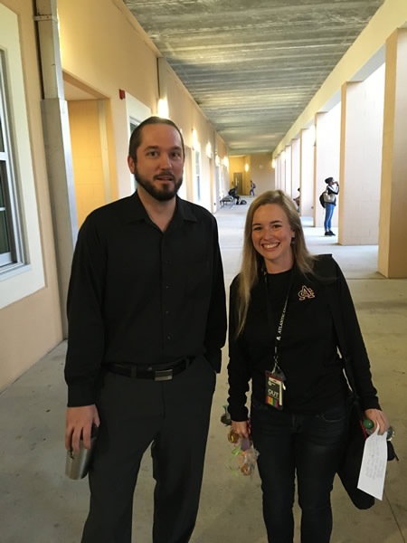 Tall man and lady wearing black