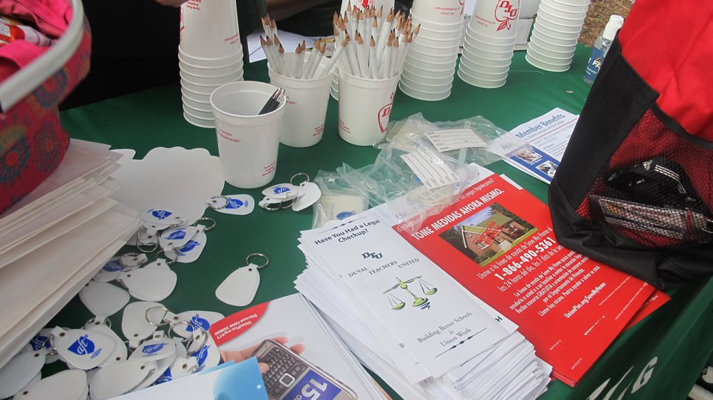 Variety of leaflets and flyers on a green table