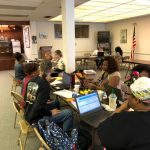 People sat at desk on laptops
