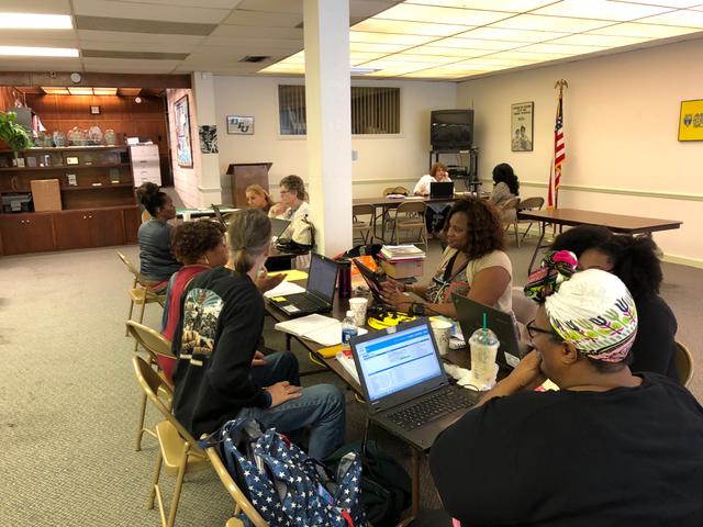 People sat at desk on laptops