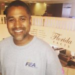 Man in FEA t shirt in front of Florida Facts banner