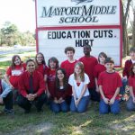 John Meeks and students in front of Mayport Middle School sign