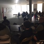 Teachers in dark lecture room with refreshments