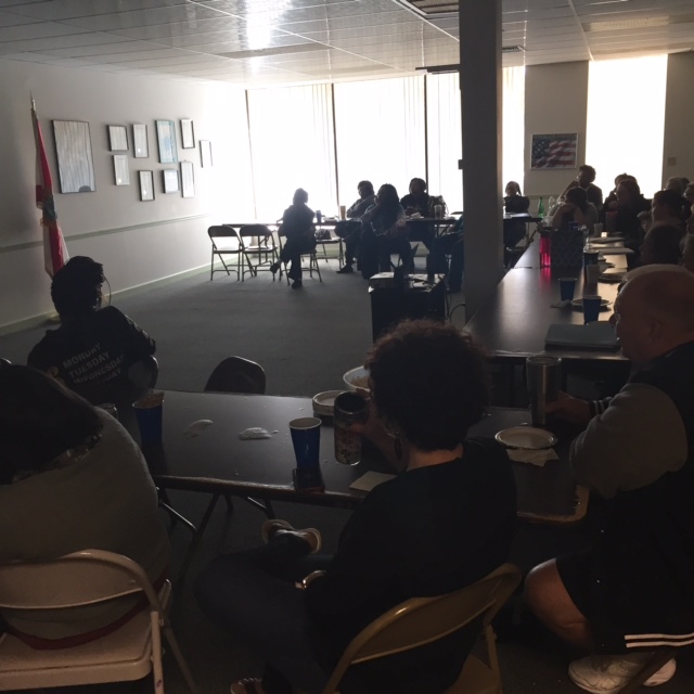 Teachers in dark lecture room with refreshments