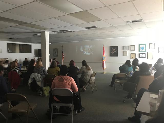 Teachers watching slideshow presentation