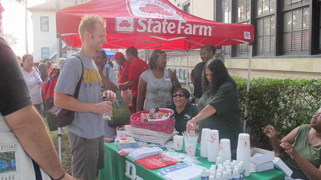 Man with ginger hair infront of state farm event tent
