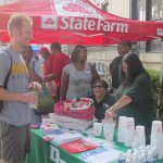 Man with ginger hair infront of state farm event tent