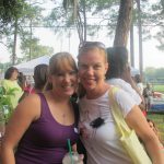 Lady in purple and lady in white shirt hugging