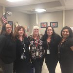 5 women wearing all black clothing